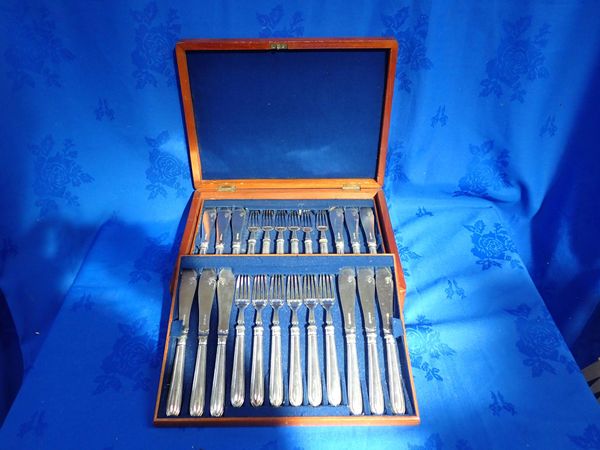 A SET OF FISH KNIVES AND FORKS IN A MAHOGANY BOX