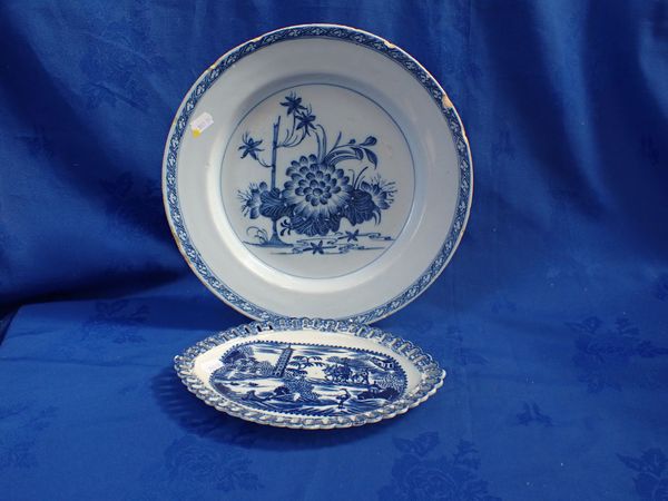 A DELFTWARE CHARGER DECORATED WITH FLOWERS