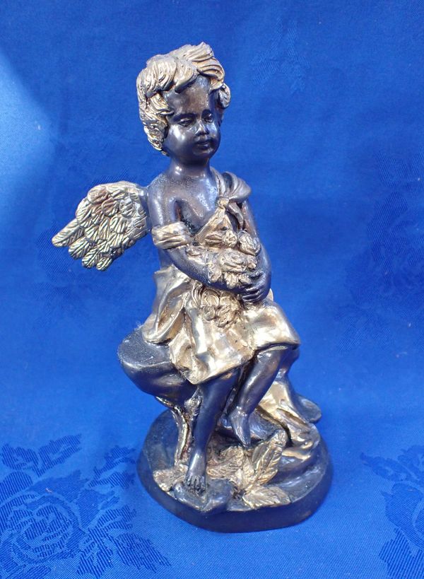 A REPRODUCTION BRONZE FIGURE OF A WINGED CHERUB