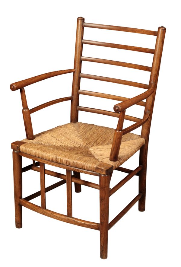 LIBERTY & CO: AN ARTS AND CRAFTS LADDER BACK ELBOW CHAIR