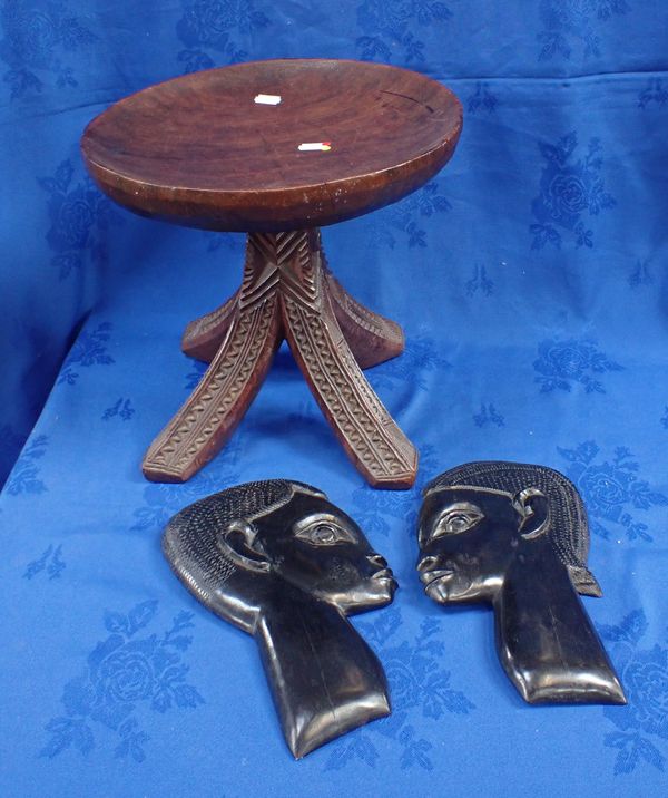 AN AFRICAN TRIBAL STYLE FOUR LEGGED STOOL