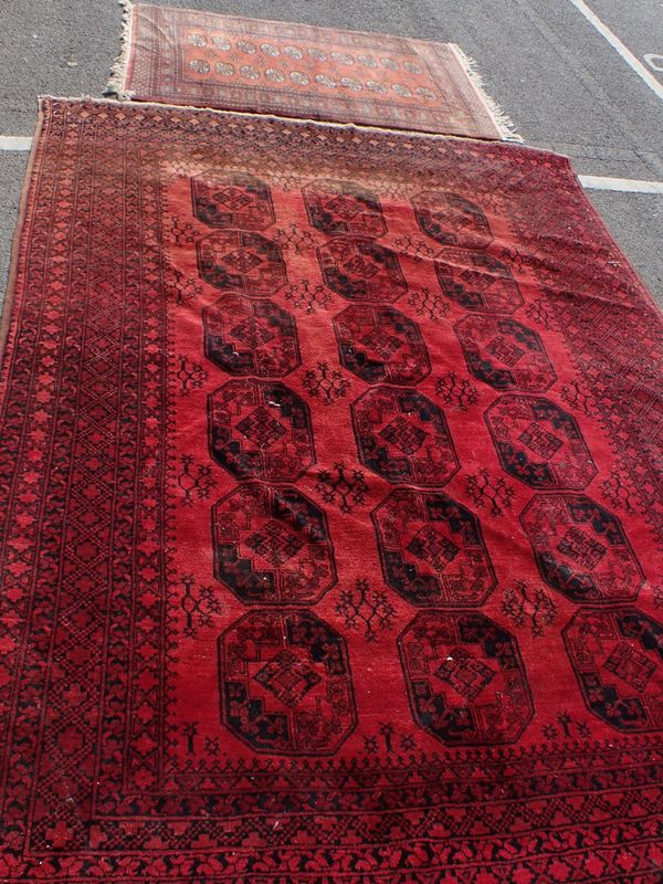 A LARGE RED GROUND RUG