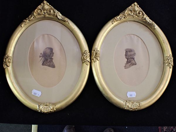 A PAIR OF GILT-FRAMED SILHOUETTE PORTRAITS