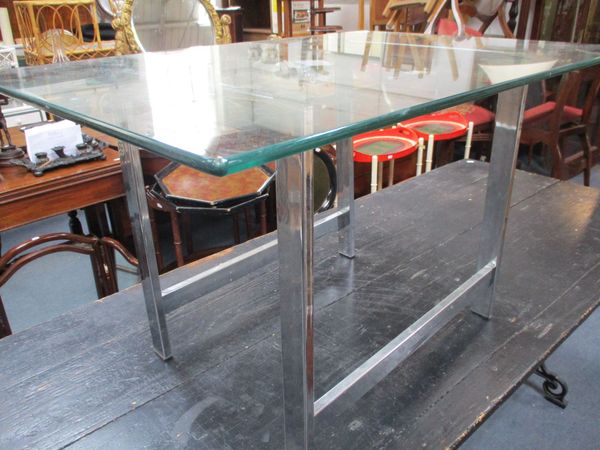 A MODERNIST GLASS TOP TABLE, IN THE STYLE OF PIEFF