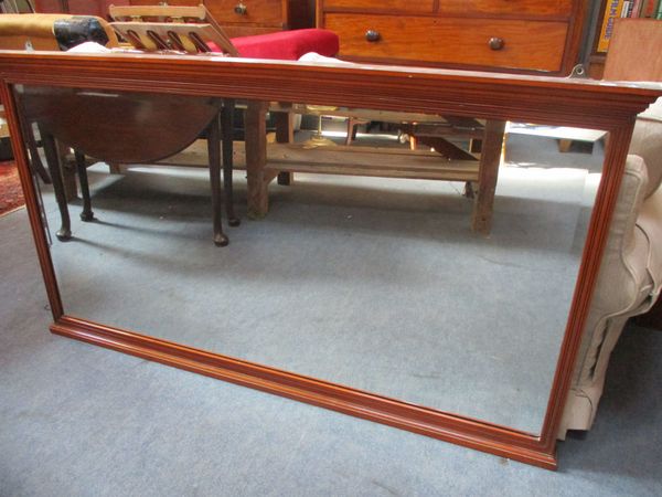 AN EDWARDIAN MAHOGANY FRAMED WALL MIRROR