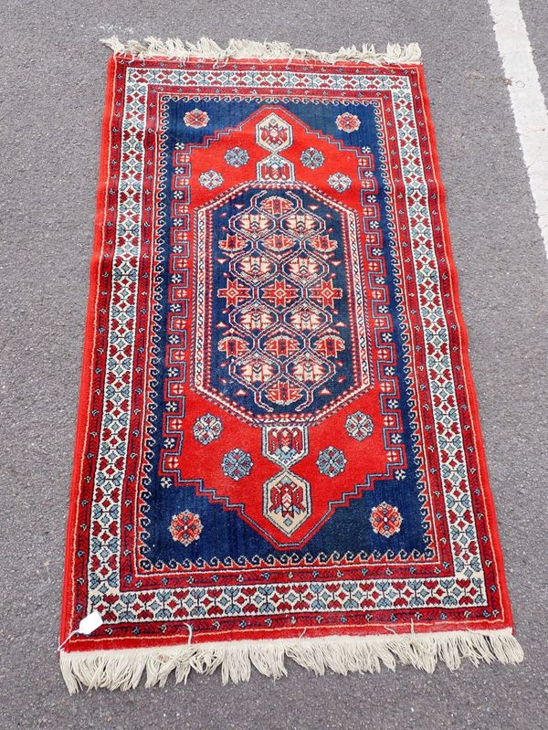 A BLUE GROUND RUG OF TRADITIONAL DESIGN