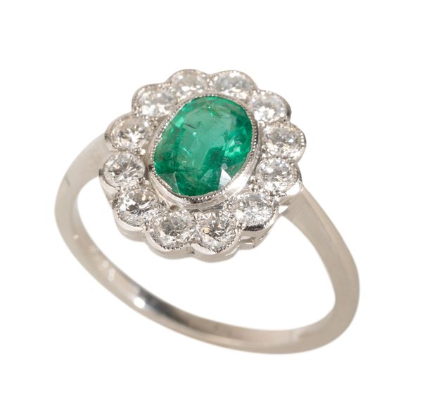 AN EMERALD AND DIAMOND CLUSTER RING