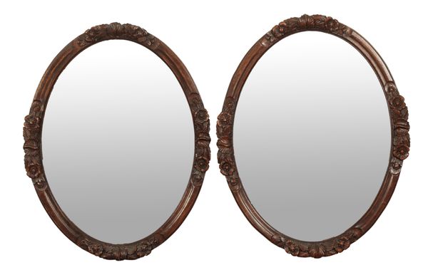 A PAIR OF VICTORIAN CARVED OAK MIRRORS