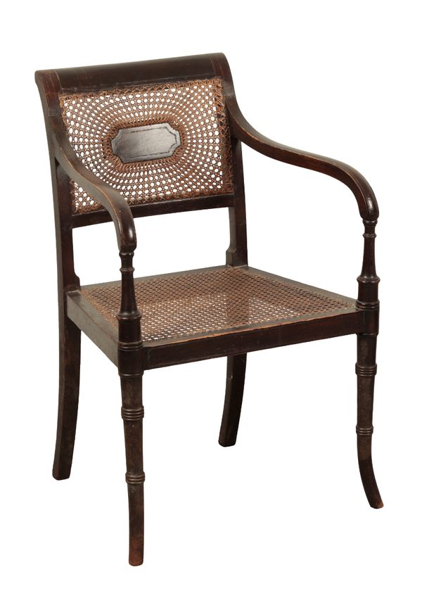 A REGENCY EBONISED AND CANED ARMCHAIR