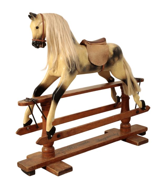 AN EARLY 20TH CENTURY DAPPLE GREY ROCKING HORSE RETAILED BY HARRODS OF KNIGHTSBRIDGE