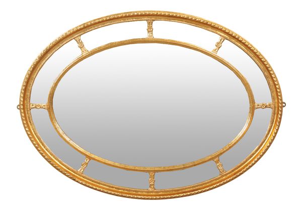 A REGENCY GILT OVAL WALL MIRROR