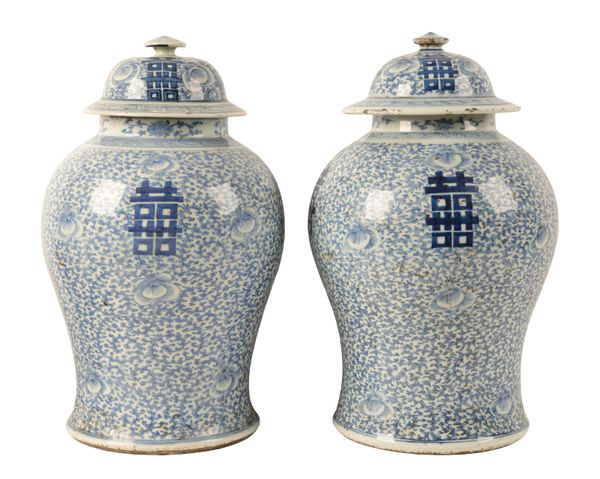 A NEAR PAIR OF CHINESE BLUE AND WHITE VASES AND COVERS