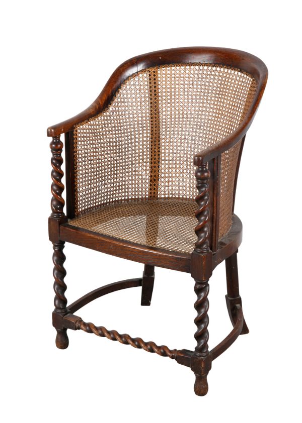 A 1930S OAK BERGERE ARMCHAIR