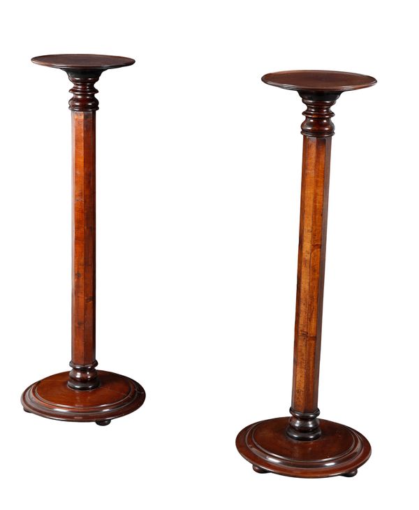 A PAIR OF MAHOGANY TORCHERE STANDS