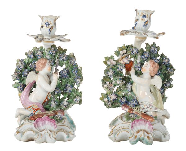 A PAIR OF DERBY PORCELAIN CANDLESTICKS MODELLED AS CUPIDS