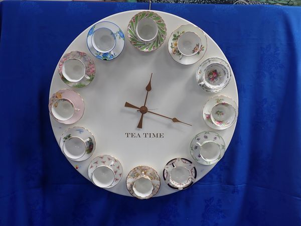 A NOVELTY 'TEA TIME' WALL CLOCK