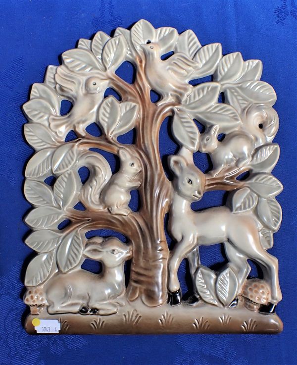 A POOLE POTTERY WALL PLAQUE, CAST WITH A TREE AND ANIMALS