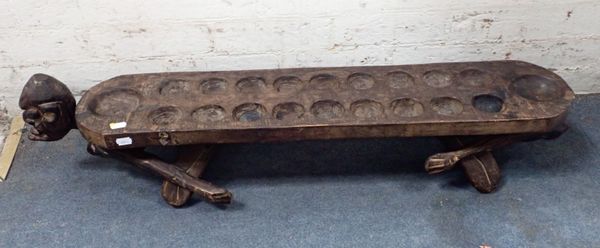 AN AFRICAN TRIBAL MANCALA GAME BOARD