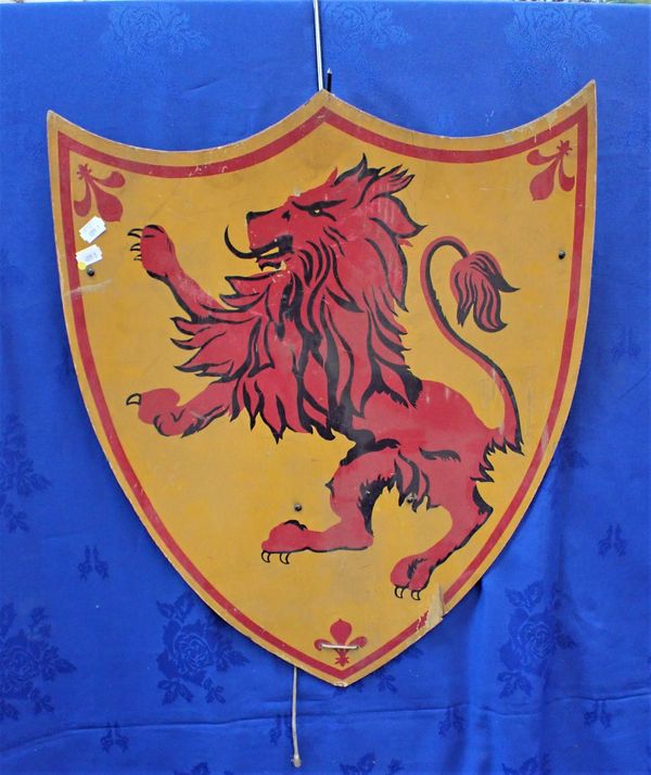 A PAINTED DECORATIVE WOODEN SHIELD