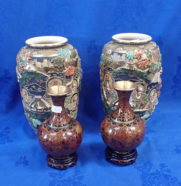 A PAIR OF ORIENTAL CLOISONNE VASES ON WOODEN STANDS