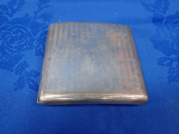 A CURVED SILVER CIGARETTE CASE