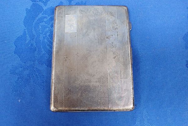 AN ENGINE TURNED SILVER CIGARETTE CASE