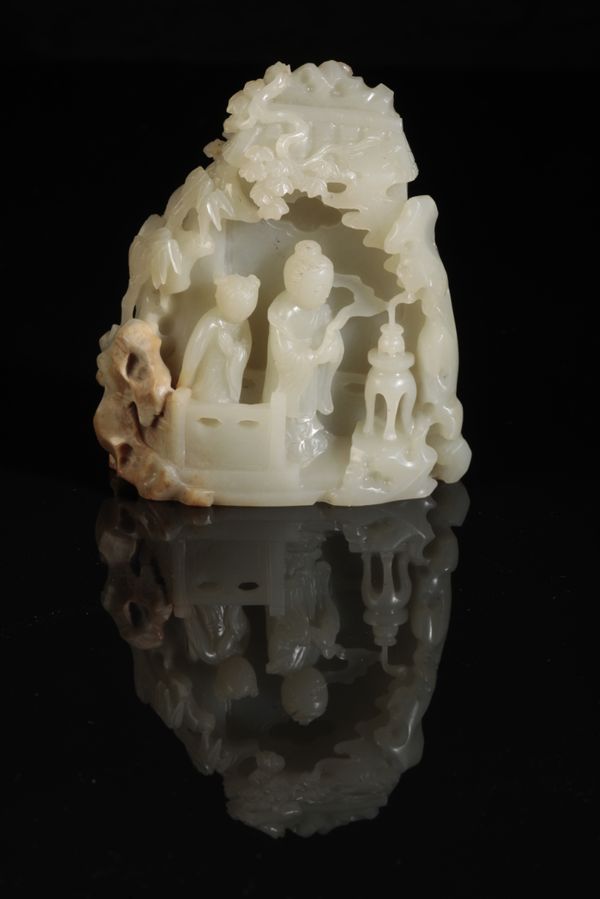 A CHINESE CELADON JADE CARVING OF TWO FIGURES IN A PAVILION