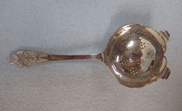 A SILVER TEA STRAINER