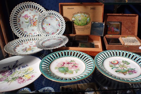 A COLLECTION OF PIERCED AND FLORAL DECORATED PLATES