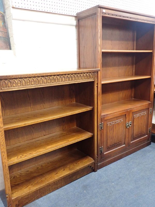 AN 'OLD CHARM' OAK OPEN BOOKCASE,WITH LINENFOLD PANELLED CUPBOARD BELOW