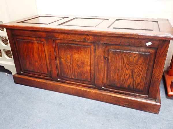 A REPRODUCTION OAK PANELLED COFFER