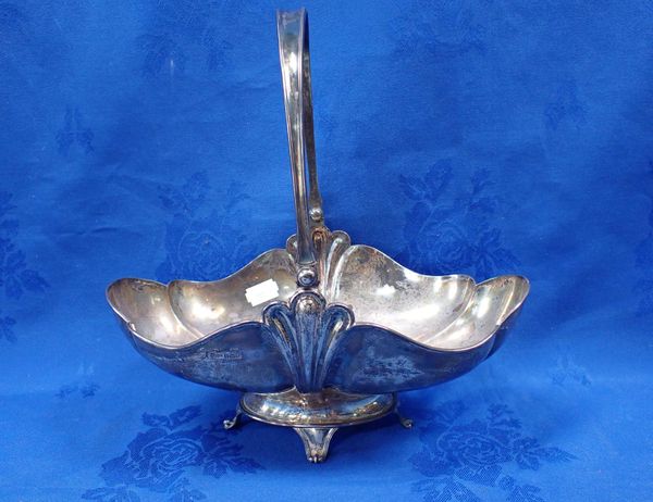 A SILVER DISH OF LOBED FORM, WITH SWING HANDLE