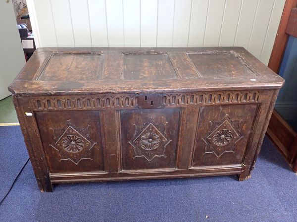 AN OAK COFFER, WITH THREE-PANELLED FRONT