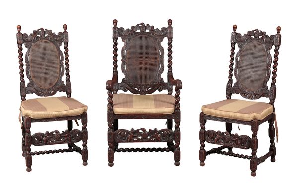 A SET OF TWELVE CHARLES II STYLE WALNUT AND CANE-WORK DINING CHAIRS