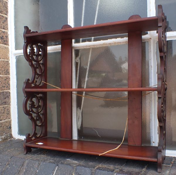 A MAHOGANY  HANGING SHELF WITH FRETWORK SIDES