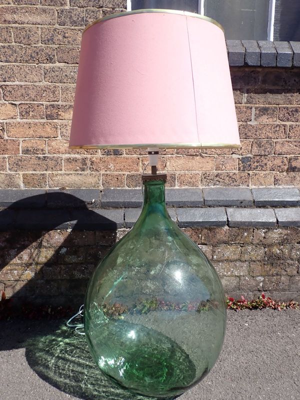 A LARGE GLASS CARBOY, FITTED AS A LAMP