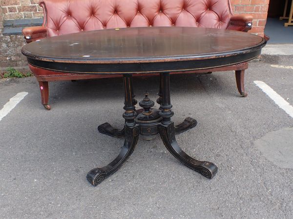 A VICTORIAN EBONISED BREAKFAST TABLE