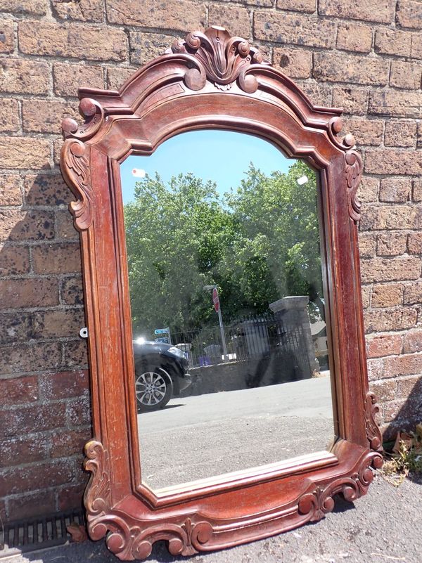 A CARTOUCHE SHAPED WALL MIRROR