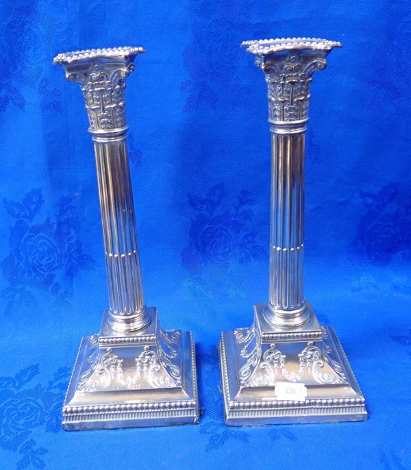 A PAIR OF LOADED SILVER CANDLESTICKS