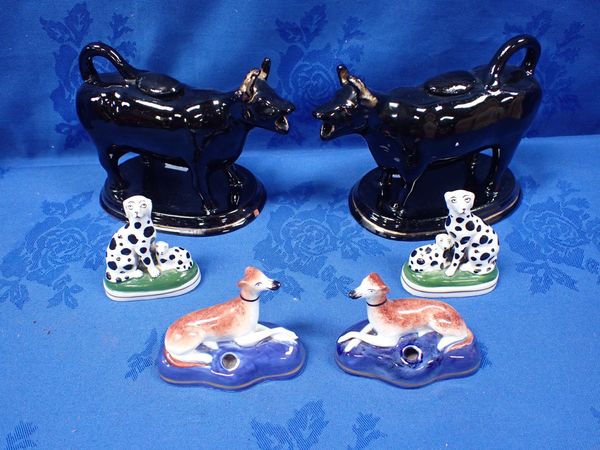 A PAIR OF PORCELANEOUS STAFFORDSHIRE STYLE GREYHOUND PENHOLDERS