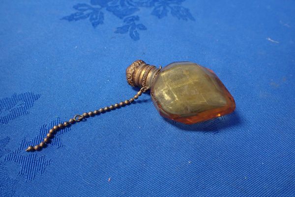 A GILT METAL AND CUT AMBER GLASS SCENT BOTTLE