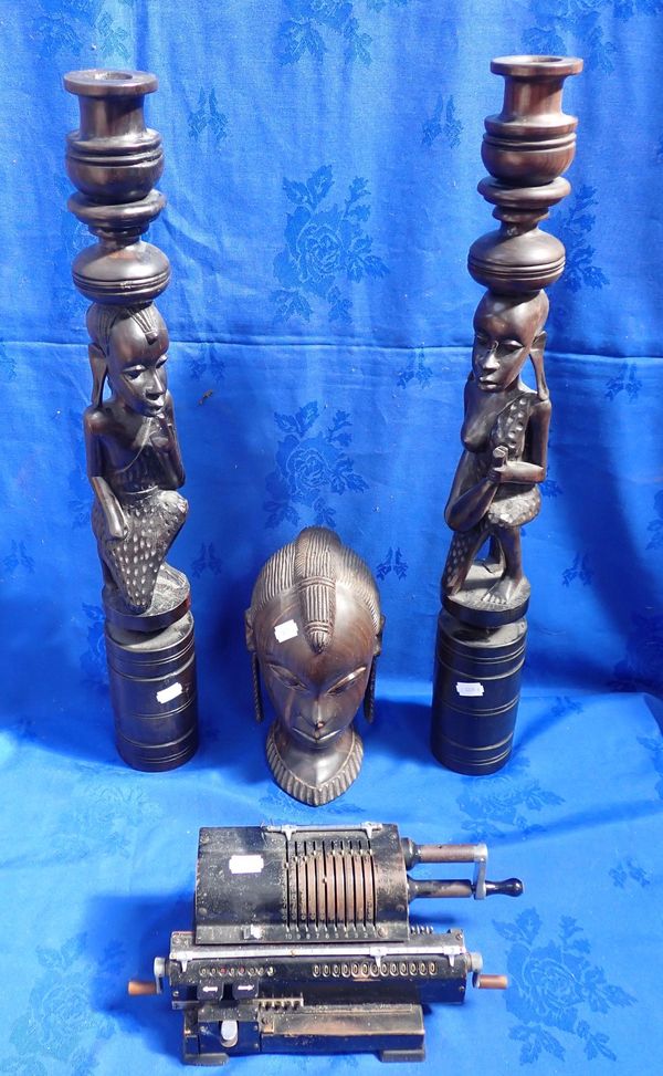 A PAIR OF AFRICAN CARVED CANDLESTICKS