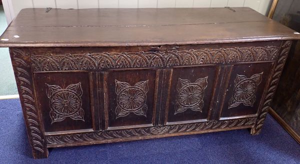 AN OAK COFFER, WITH CARVED PANELLED FRONT