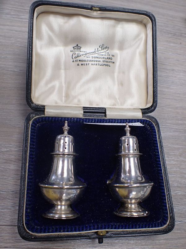 A PAIR OF SILVER PEPPER POTS