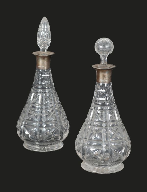 A PAIR OF CUT GLASS AND SILVER COLLARED DECANTERS
