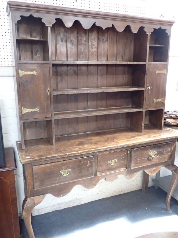 AN EDWARDIAN STAINED PINE DRESSER, ON CABRIOLE LEGS