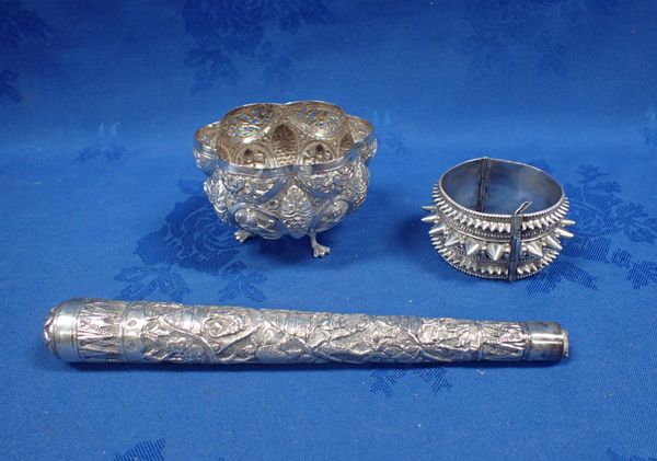 AN INDIAN REPOUSSE WHITE METAL BOWL ON DUCK FEET