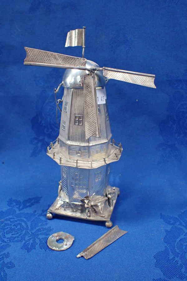 A WHITE METAL WINDMILL