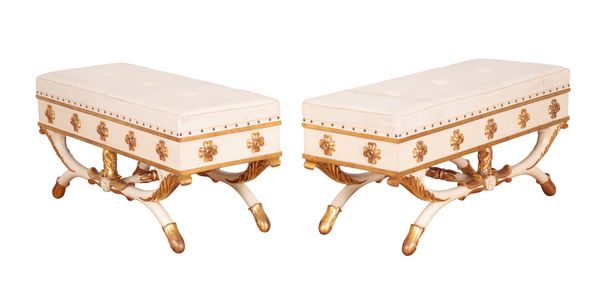 A PAIR OF REGENCY STYLE WHITE-PAINTED AND PARCEL GILT X-FRAME STOOLS