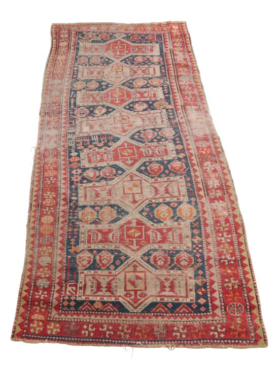 AN ANTIQUE CAUCASIAN LONG RUG